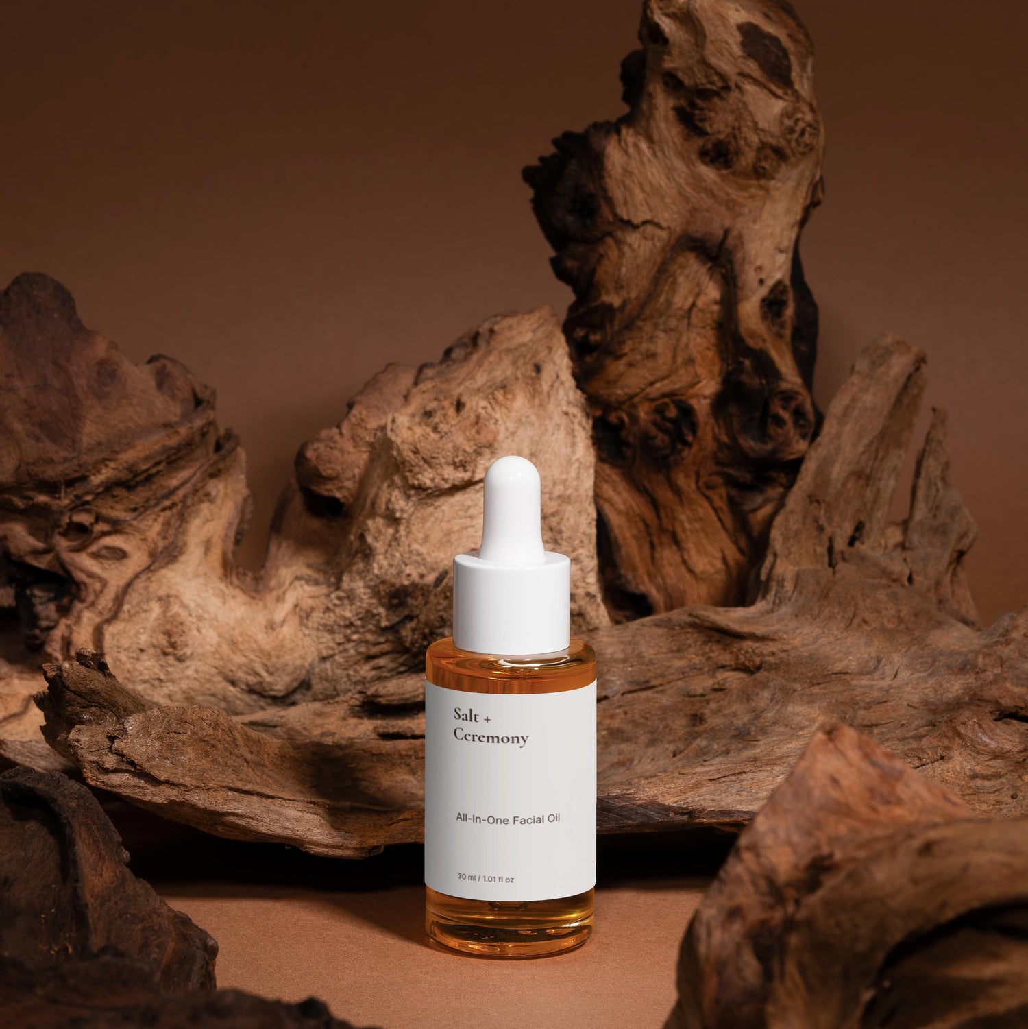 Skincare dropper bottle with a label on a brown background with wooden textures