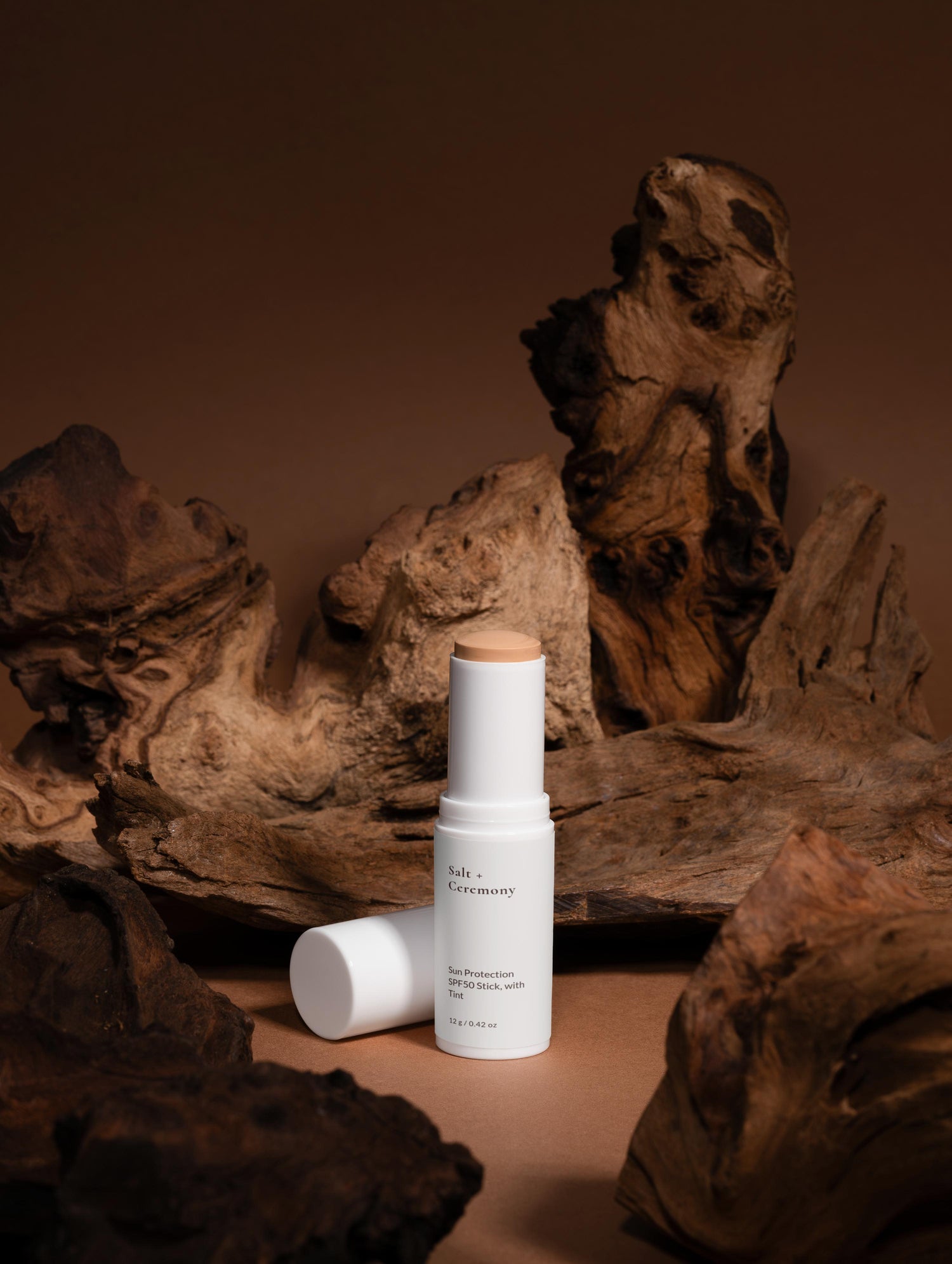Skincare products on a wooden surface with a brown background